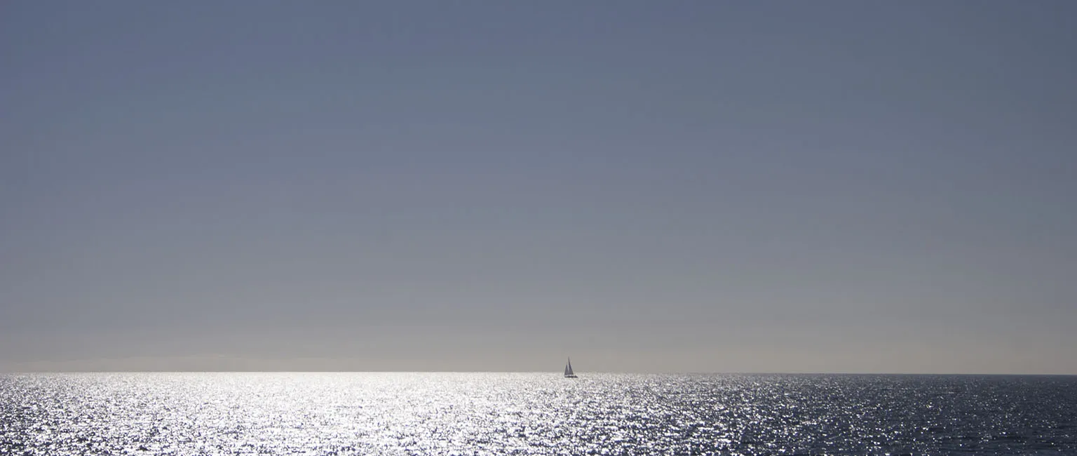 Sailboat in the morning light between Santa Catalina Island and the mainland