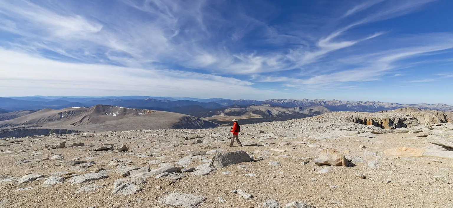 Headed down on the summit plateau. Cirque Peak and New Parmy Pass on the left in the back