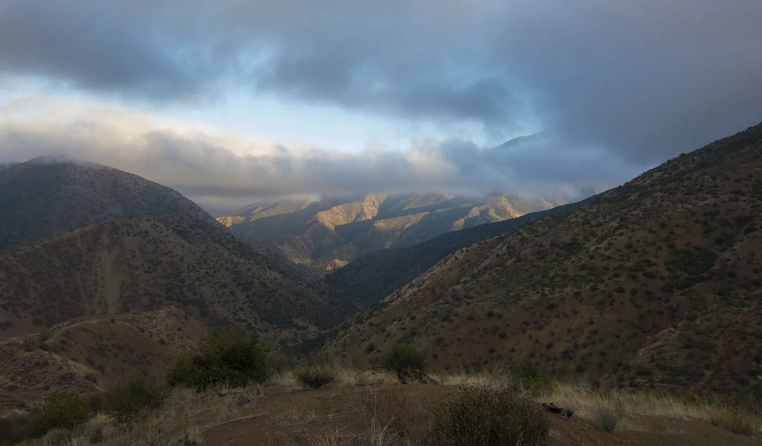 Looking down from the Johnston Ridge Trail into the the Sespe Creek gorge and the Topa Topa Mountains in the back. Topa Topa Peak hiding in the clouds on the right
