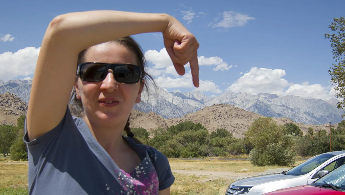 Em pointing at Mt. Whitney from the parking lot of the Easter Sierra Interagency Visitor Center in Lone Pine